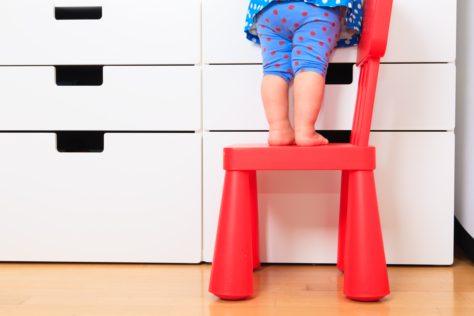 child standing on step-stool